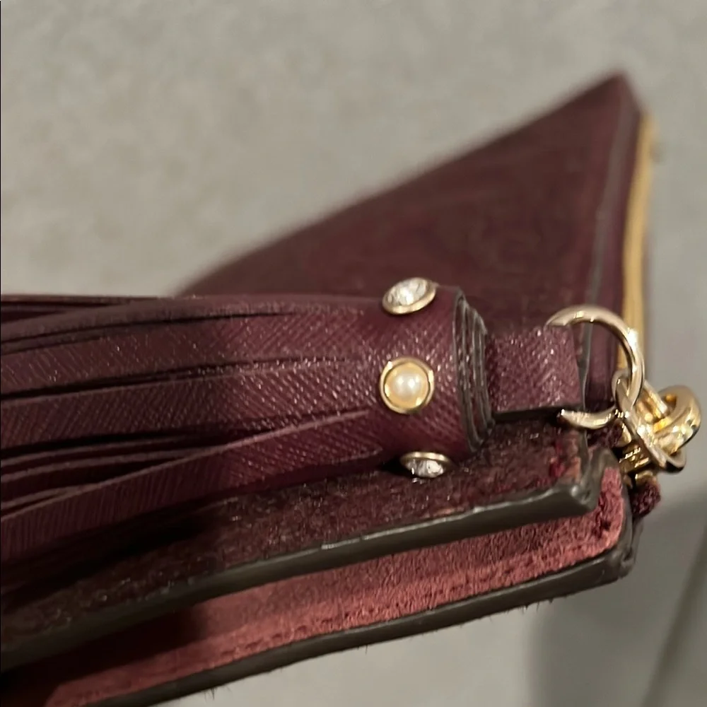 NWT kate spade burgundy suede pouch with gold logo